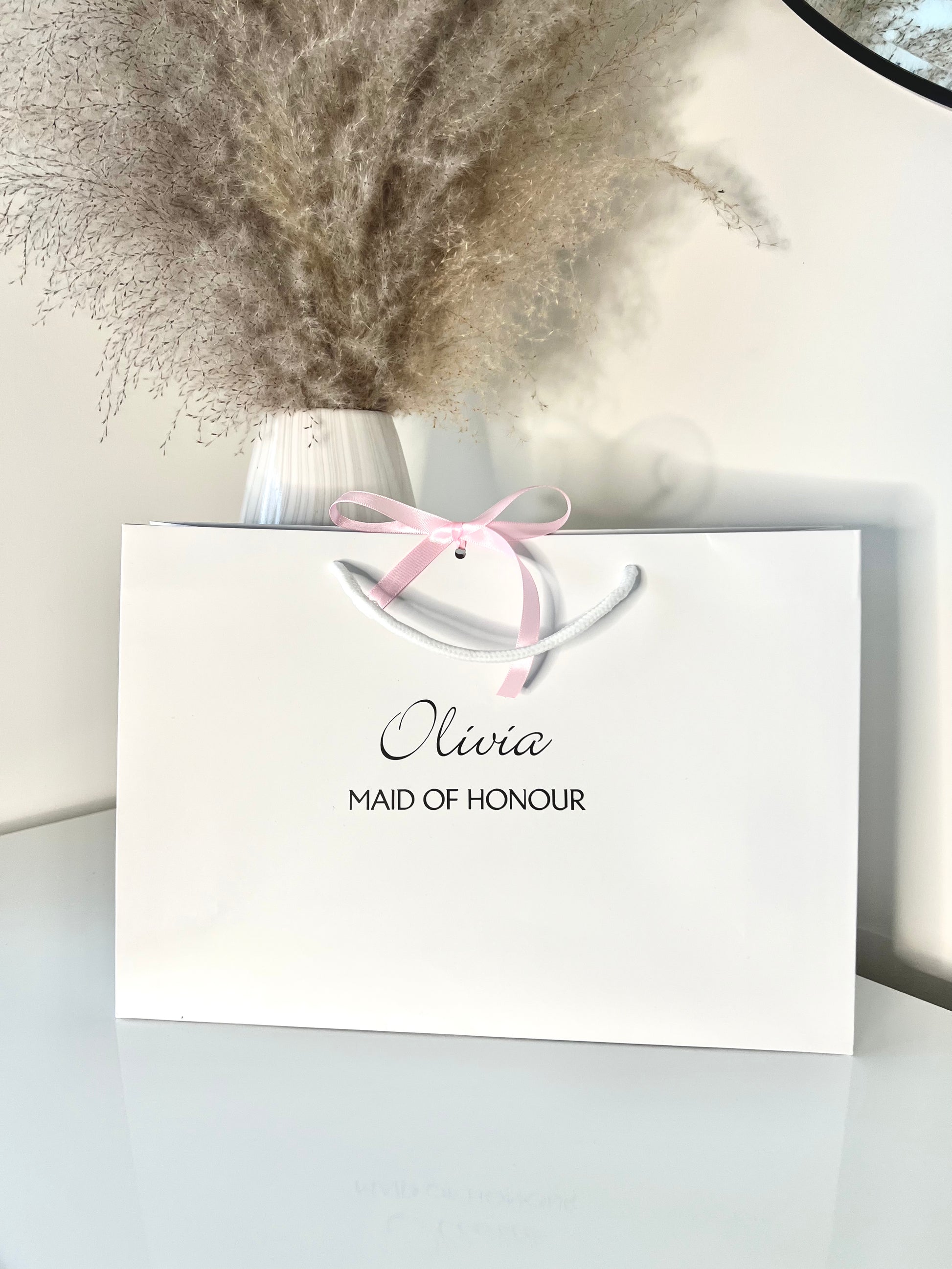 White gift bag with ribbon